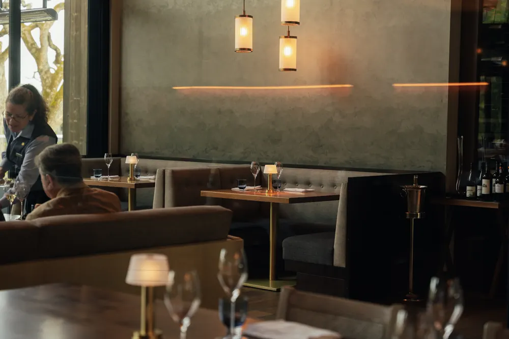 warm restaurant dining room with pendant lights