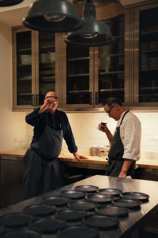 two chefs tasting in a kitchen